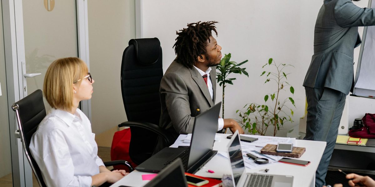 A professional confidently presenting ideas to a group, demonstrating expertise and clear communication.