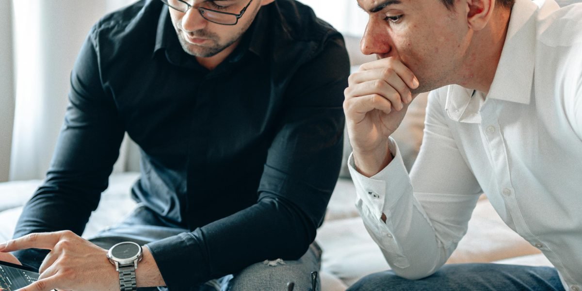 Investors at a table intently reviewing a pitch deck during a meeting, signaling critical decision-making.