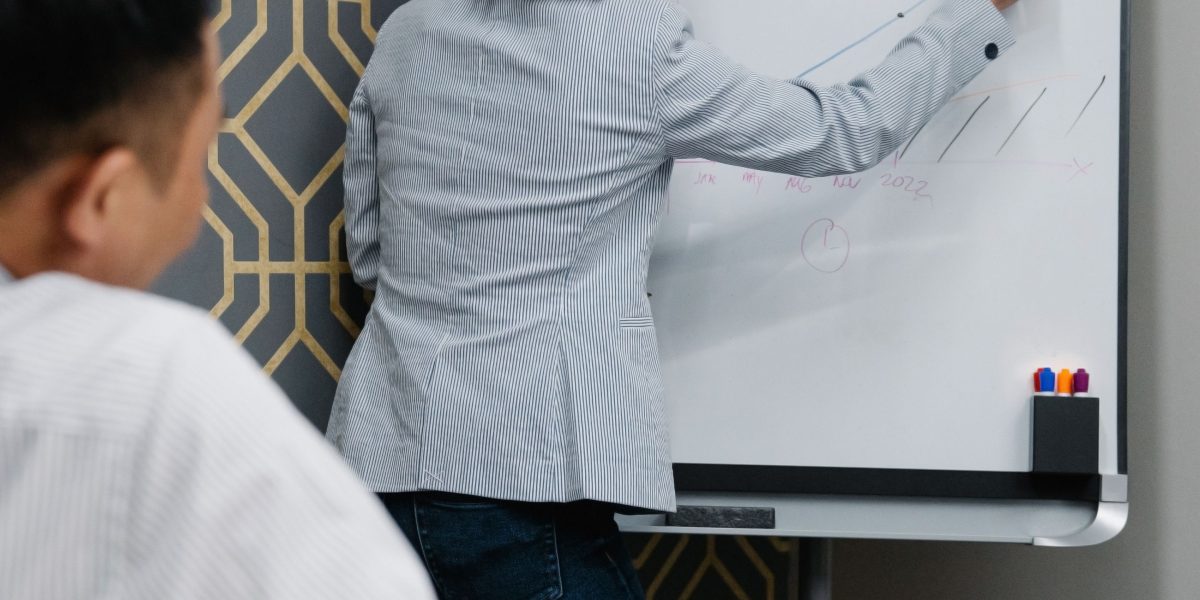 A team actively discussing and visualizing their system architecture or strategic plans on a whiteboard.