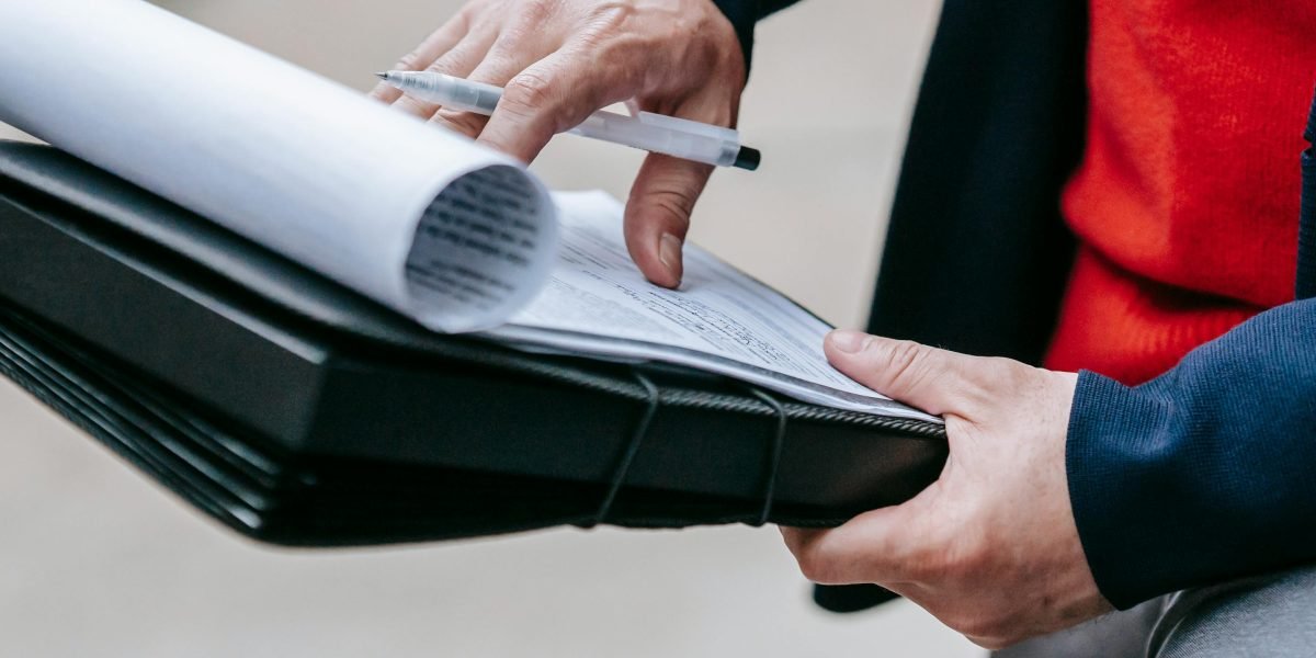 A person meticulously going through a checklist, symbolizing due diligence and vendor evaluation.