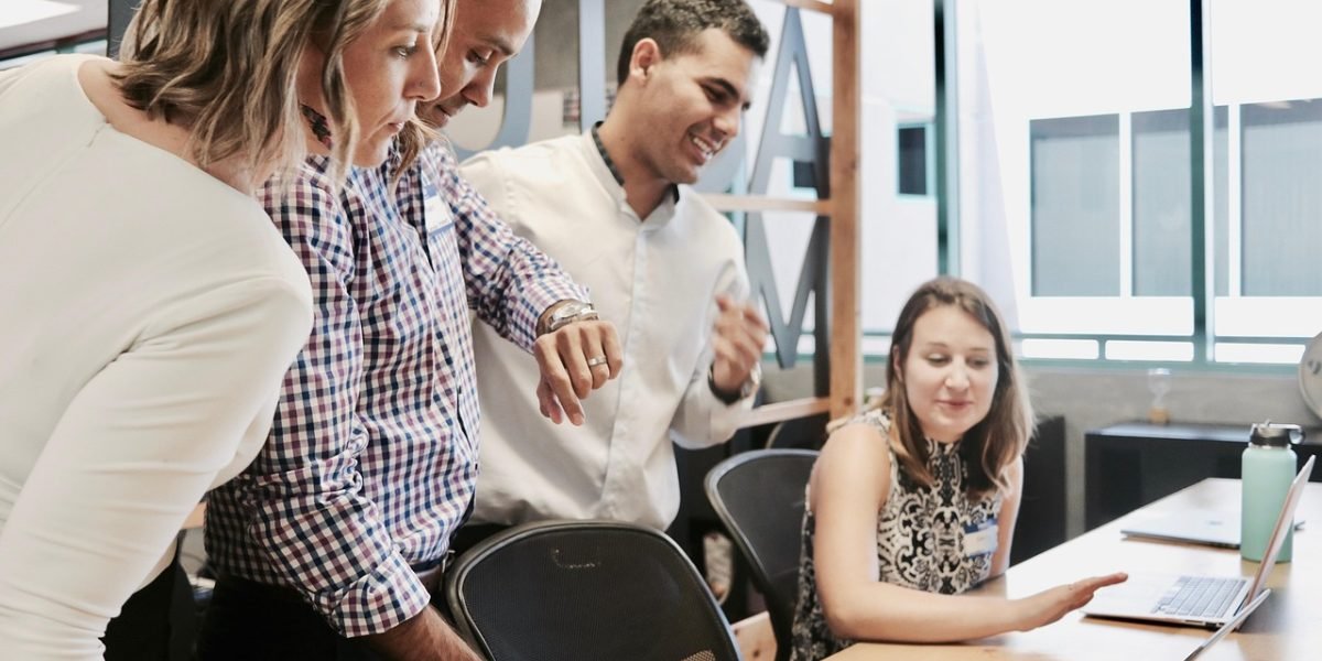 Professionals engaged in a discussion, symbolizing the critical analysis of strategic business moves.