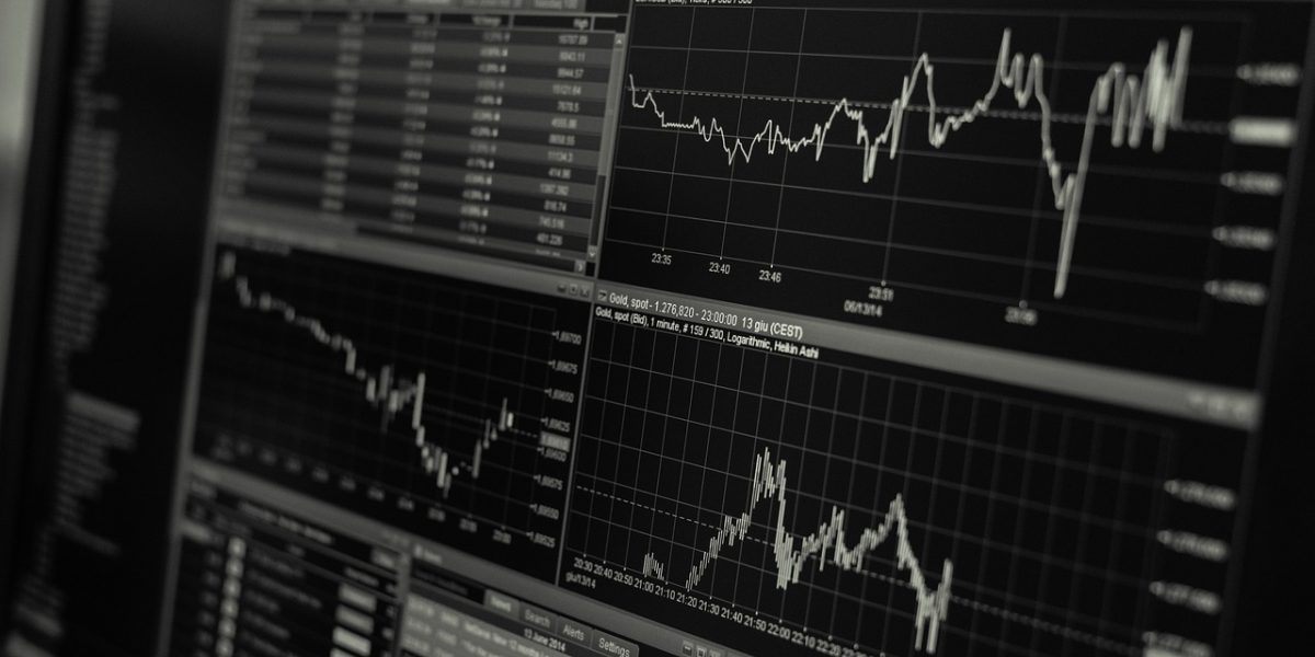 Individuals reviewing financial data, reflecting the cautious yet optimistic investor sentiment following the merger.