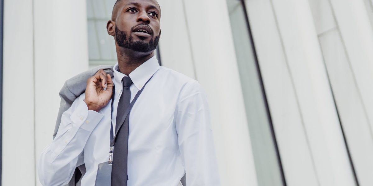 A professional individual thoughtfully reviewing investment documents, seeking new opportunities.