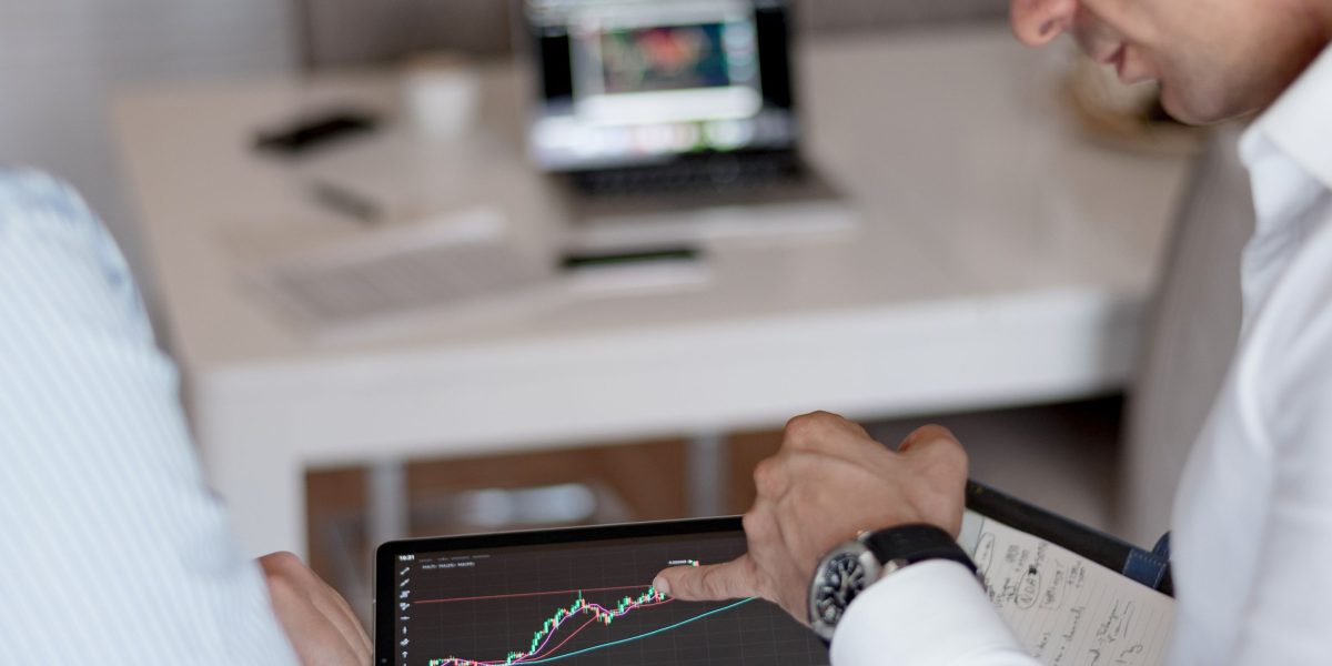 Investors thoughtfully analyzing market data to identify promising business opportunities.