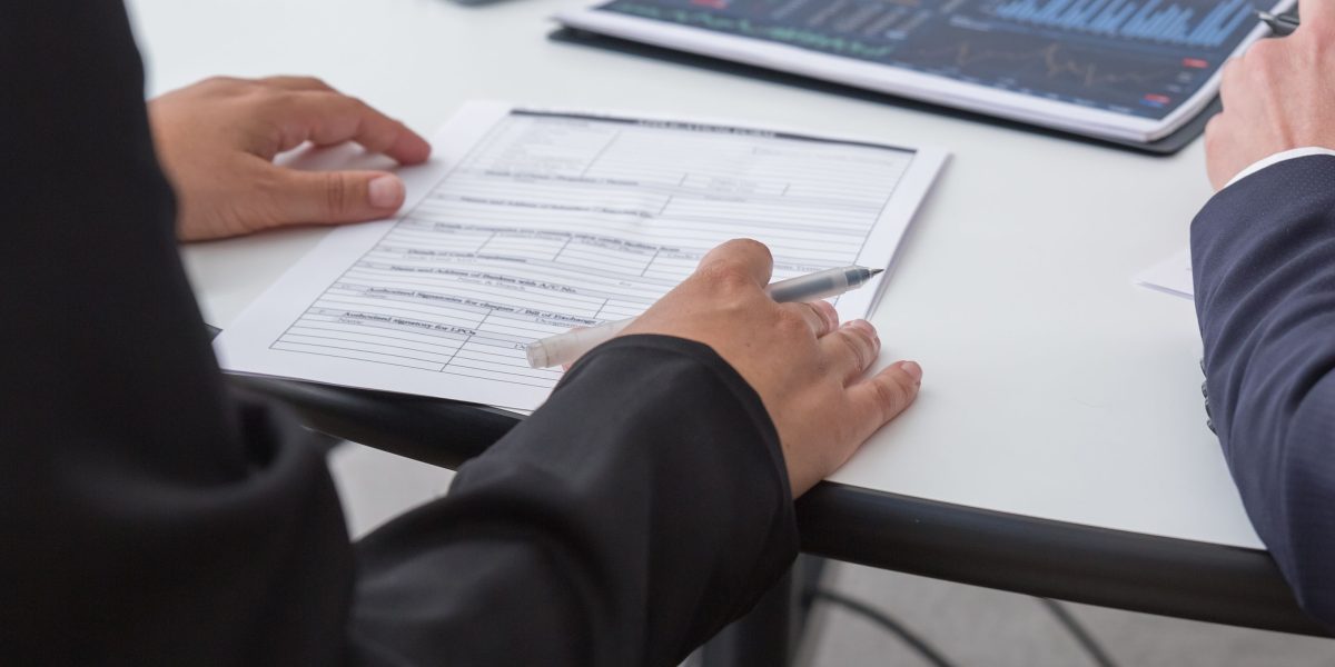 A business team collaborating around a table, reviewing performance data and financial reports to assess investment outcomes.