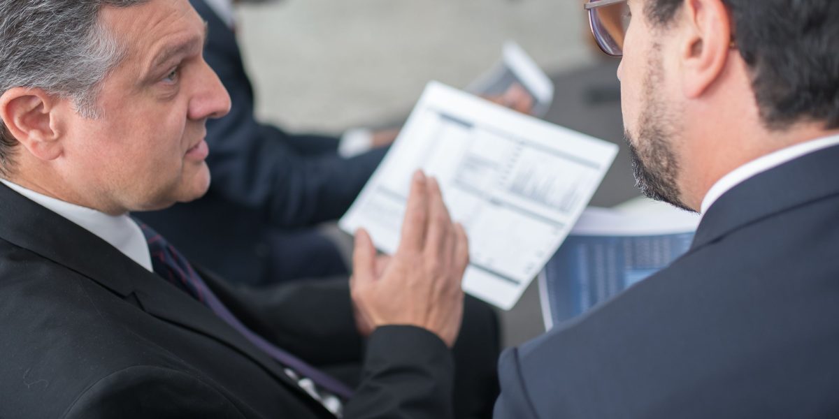Financial advisors collaborating to strategize capital allocation and investor mandates.