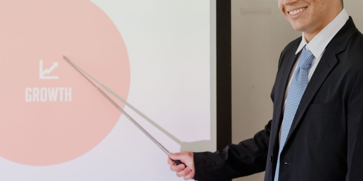A poised professional delivering a crucial pitch in a business meeting, aiming for investment success.