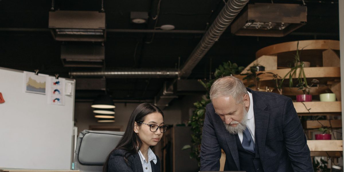 An experienced professional providing guidance and advice to a young entrepreneur, illustrating post-investment support.