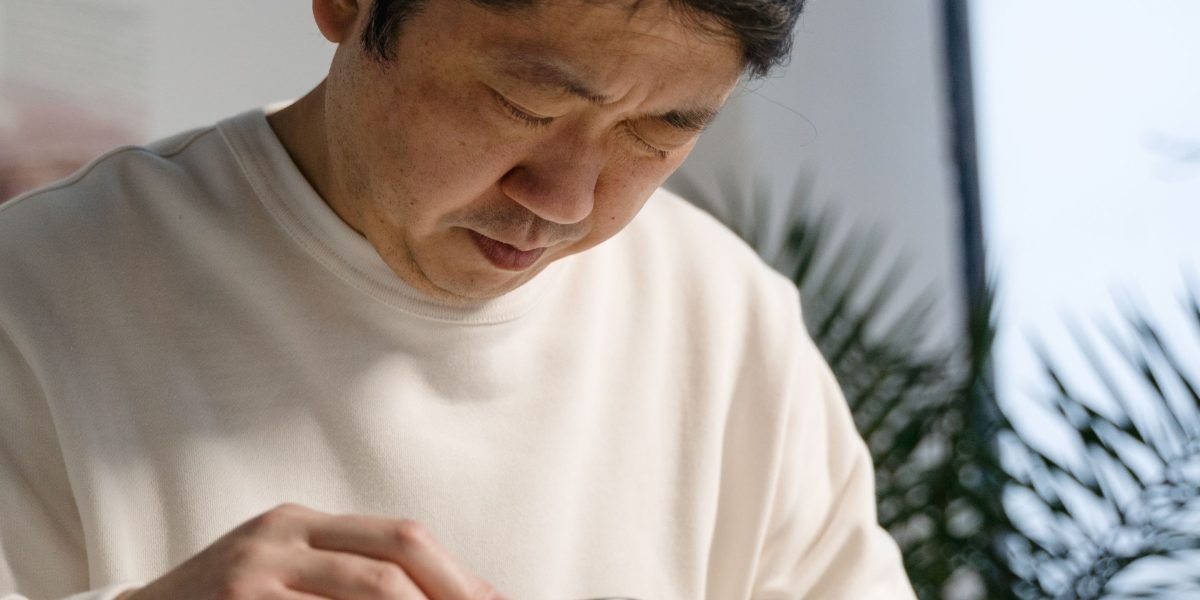 A person carefully sifting through information, symbolizing the challenge of finding valuable insights amidst vast data.
