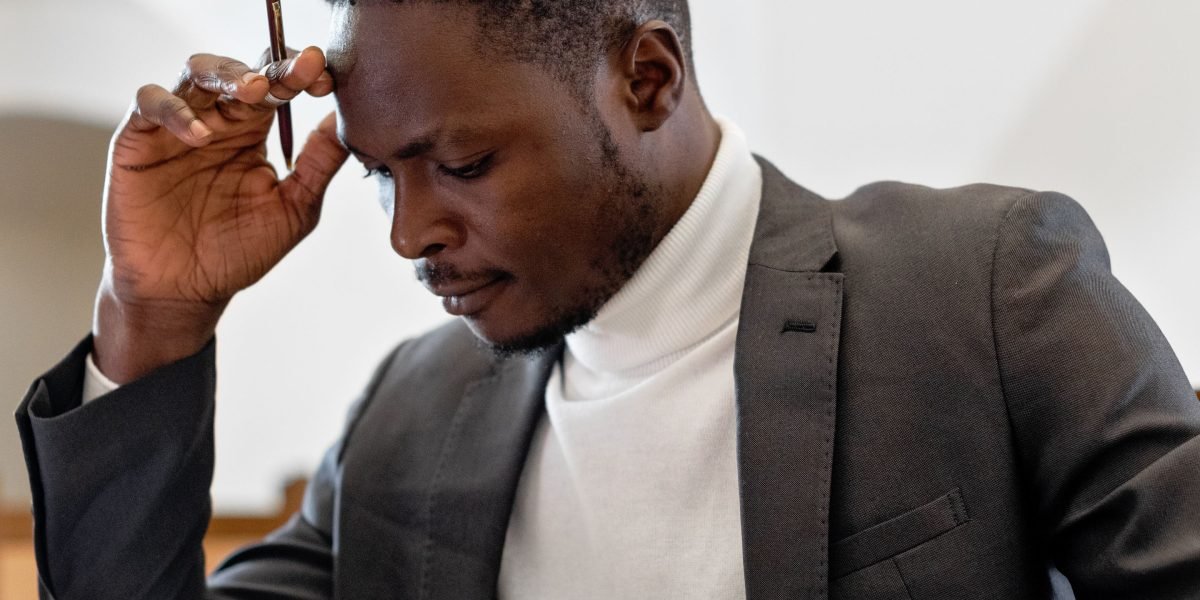 An individual deeply in thought, symbolizing the critical moment of making a major business decision regarding an advisor partnership.