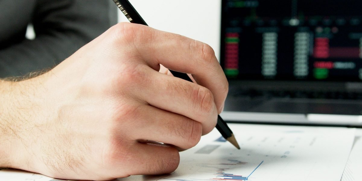An individual studies market data to understand funding flows and identify opportunities.