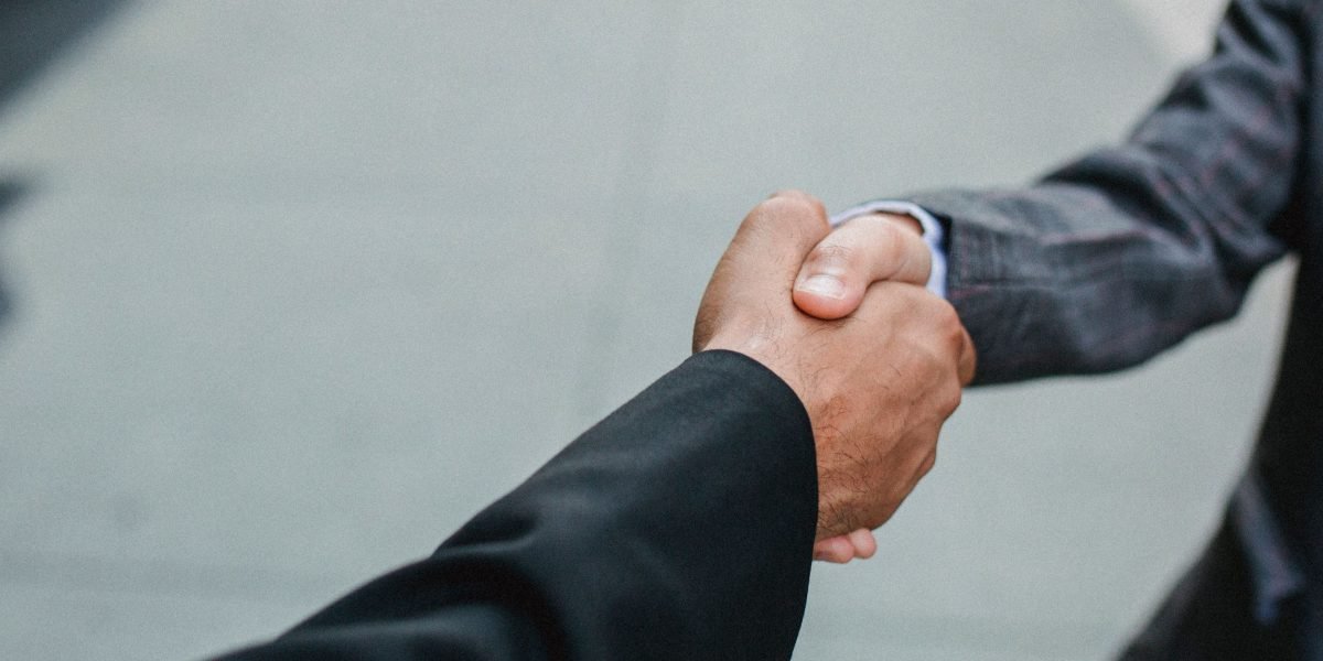 Business professionals concluding a successful negotiation with a handshake.