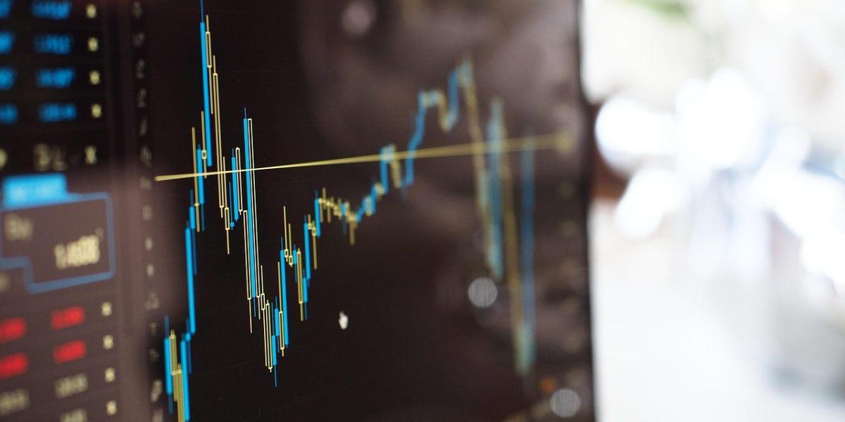 A person analyzing data and reports to track product adoption and market signals.