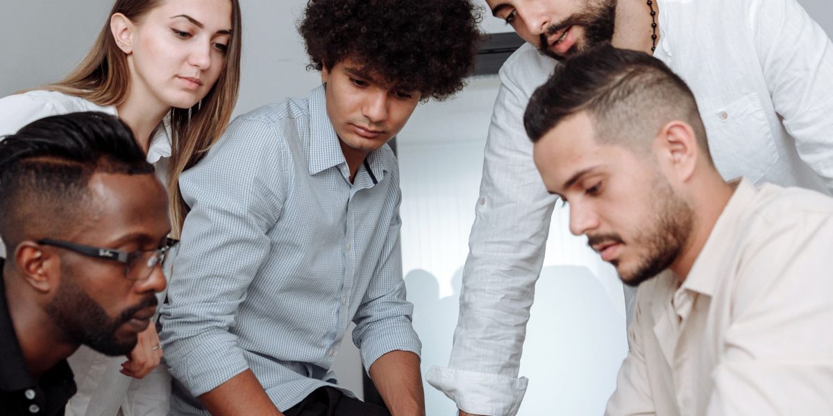 A team of professionals collaborating, symbolizing the combined roles of investor and advisor in guiding growth.