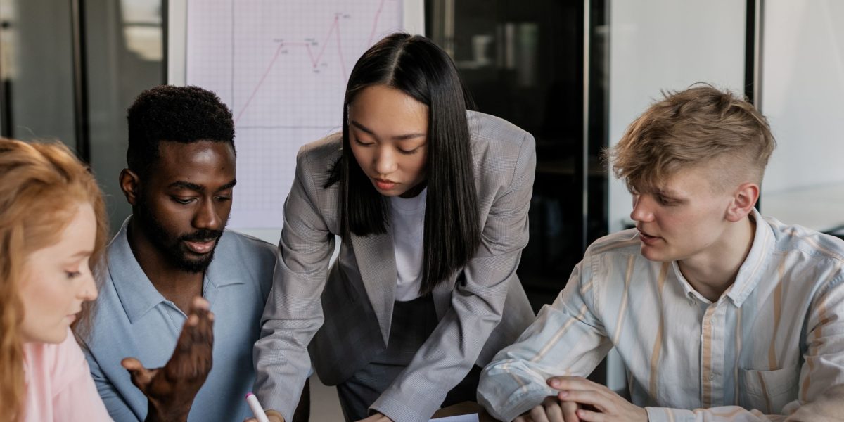 A diverse team collaborates, symbolizing the founders, operators, and investors analyzing critical tech market signals.