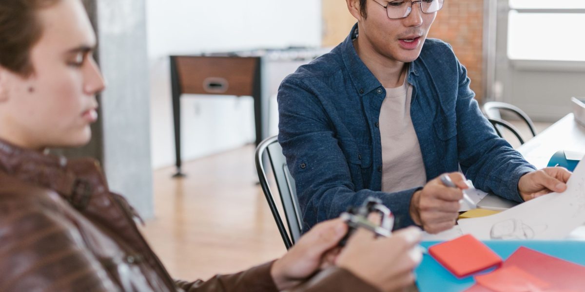 An experienced mentor provides guidance to a startup founder, symbolizing the support from angel investors or accelerators.
