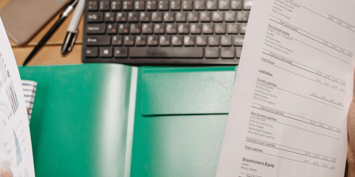 A professional looking thoughtfully at a financial report, symbolizing comprehension of complex investment landscapes.