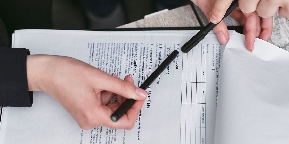 Professionals engaged in a thorough review of documents, symbolizing the detailed due diligence process for investments.