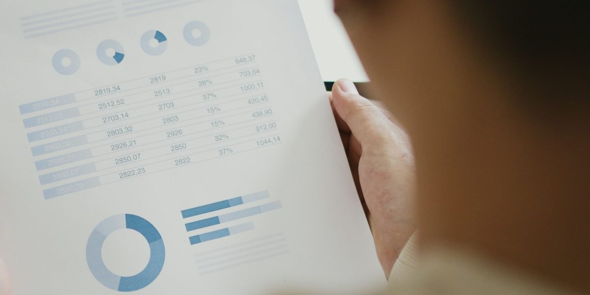 An individual deeply focused on research, sifting through information to make informed investment decisions.