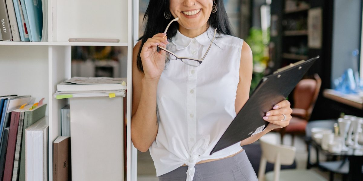 An organized business owner managing financial records, ensuring compliance and smooth operations after receiving grant funding.