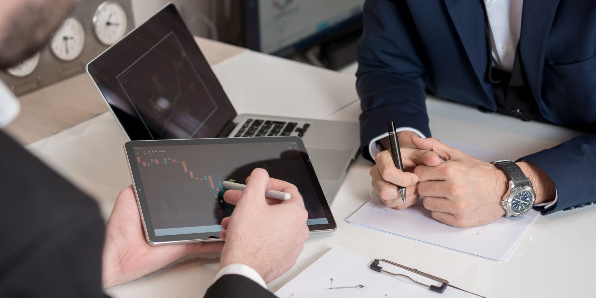 Professionals in an investor meeting, discussing various funding strategies and partnership dynamics.