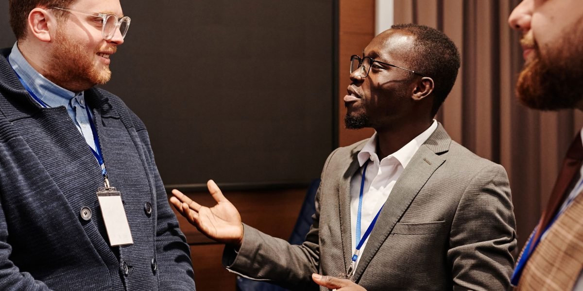 People connecting and exchanging ideas at a professional networking event, fostering potential investment relationships.