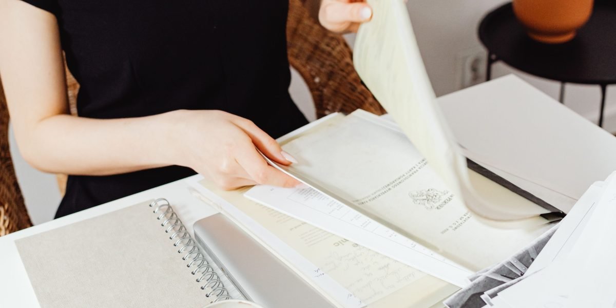 A person diligently organizes essential documents for investor pitches and due diligence.