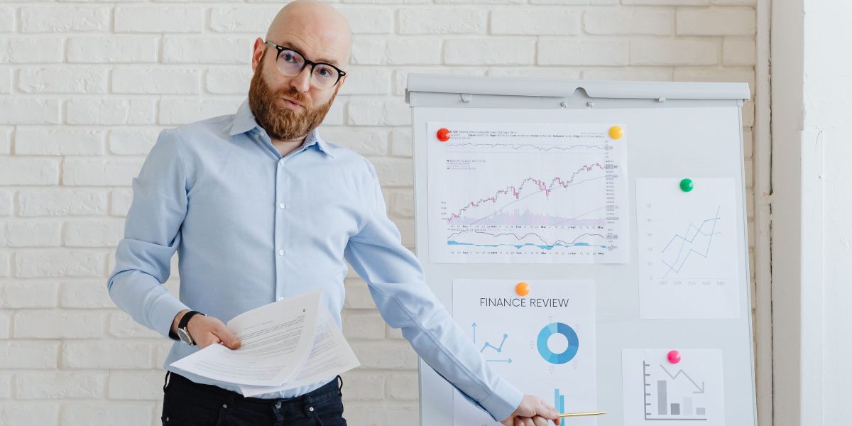 A confident person presenting a business plan in a professional setting, symbolizing the effective pitching of a company to investors.