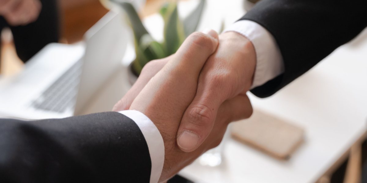 Business professionals engaged in a focused negotiation, representing the critical discussion of valuations and term sheet essentials for founders.